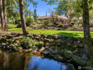 A Gardeners paradise, beautiful level lot with incredible privacy watch the salmon swim up Bear Creek from your lawn.
