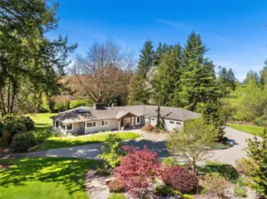 A circular stone paver driveway with parking for 8 cars greets you at the entry.