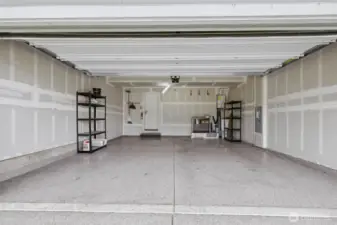 2 car garage w/ epoxy floors, and a tankless water heater on right.