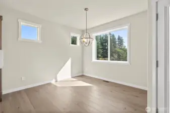 Charming dining area with abundant natural light featuring large corner window.