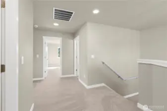 Spacious upper landing with soft carpet and recessed lighting.