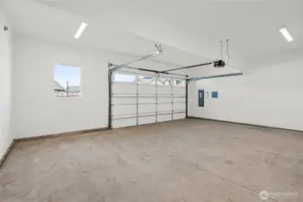 Double car garage is drywalled and includes standard garage door opener.