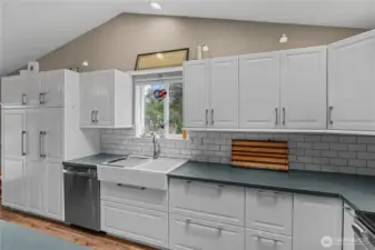 Under Cabinet Lighting, Farmhouse Sink, Oversized Pantry Cabinets and Window overlooking the yard.