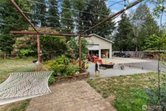Gorgeous Yard w/Blueberries, Fruit Trees and Garden Space. Patio for Hammock (Seller is taking Hammock)