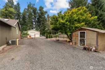 Driveway to the Shop. On the Right is the Greenhouse w/Power. Heat Pump on the Left.