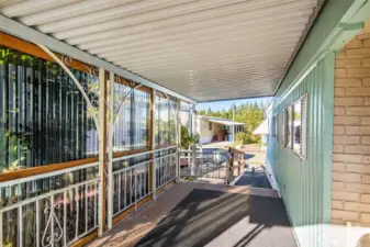 Extended covered patio provides shade and comfort year-round—ideal for quiet afternoons or visiting with neighbors.
