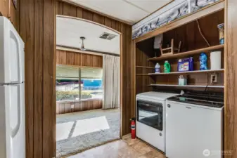 Cozy kitchen with natural light and vintage charm, overlooking the dining area for an open, airy feel.