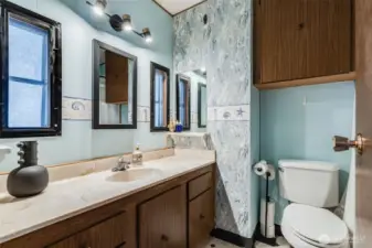 Full guest bathroom with a convenient tub/shower combo and large vanity with storage.