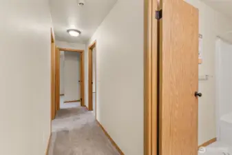 Hallway to bedrooms, full bath to the right