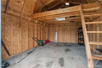 Work shop? She-shed? Or just extra storage with a convenient roll up door