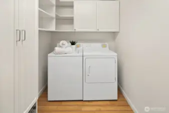 In-unit laundry and storage room with custom closet system by Closet by Design