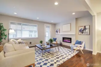 Spacious living room area adjacent to kitchen.  Access access to covered deck.