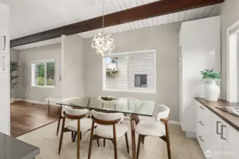 Bright and airy, this dining space is great for smaller crowds, and the open layout leaves room to expand your table on those days when everyone is here! Don't miss the coffee bar to the right - convenient countertop ports allow cords to run down and plug into outlets inside the cabinets, so it's always looking sleek.