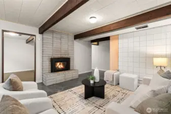 Lower level is a perfect setup for guests or teens, with 2 BRs, large rec room and updated 3/4 bath. Down the hallway at the center of this photo is a laundry room with storage, where you'll also find the furnace and tankless water heater.