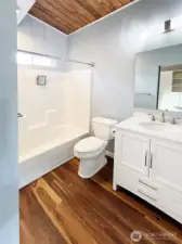 Full bath in ADU - vaulted ceilings and window for light & added ventilation.