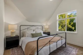 Primary bedroom on second floor accented with dynamic vaulted ceilings.