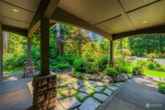 Front door view that's facing the street. Gorgeous foliage and flowers.