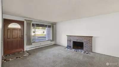 Wood burning fireplace in living room.