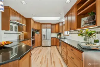 Full tile backsplash, undermount sink, stainless appliances and under cabinet lighting.