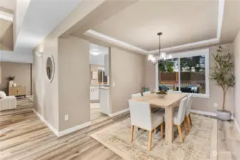 A view of the circular floorplan with dining room to the right, hallway to the family room on the left and kitchen in the middle.