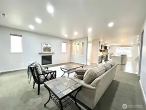 The heart of the home, the living room  An open layout, the space seamlessly connects to the kitchen for a natural flow.features a cozy fireplace as its focal point