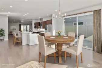 Large windows and glass doors flood the room with natural light
