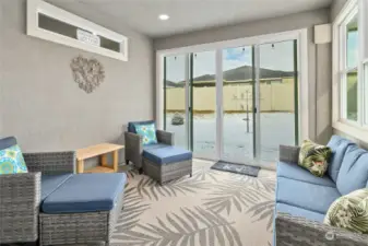 The enclosed porch extends the living area, providing a peaceful retreat to enjoy the outdoors year-round.