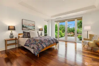 The warm wood floors beautifully complement the light and bright Primary, with it's coved ceiling craftsman detail.