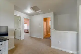 loft looking into bathroom strait ahead, bedrooms to the left, staircase in front to the right