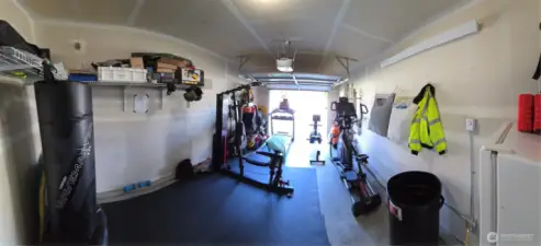 garage with new garage door, ambiant heat, and updated electrical