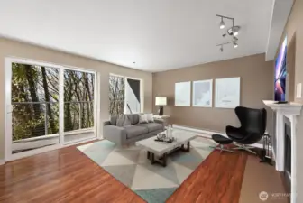 With warm, wood laminate flooring and a glass door to a private deck. (virtually staged)
