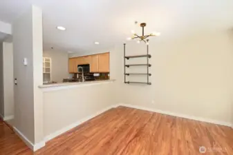 The kitchen opens to the dining room. And the wall mounted shelving conveys.