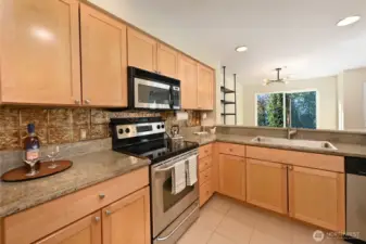 The kitchen counters are solid surface, the appliances are electric. And the HUGE kitchen sink comes with an updated gooseneck faucet.