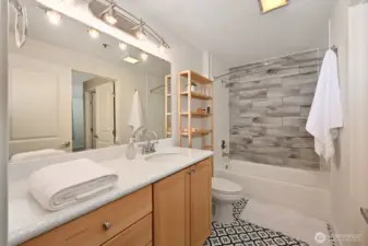 The bath includes a full tub, large mirror and great storage.