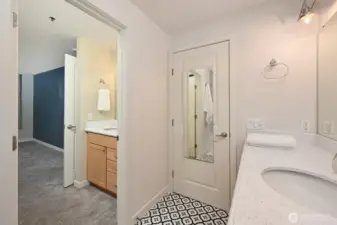 The "Jack & Jill" bathroom opens to both the hall and the primary bedroom. And there's separate sink. And vanity in the primary bedroom.