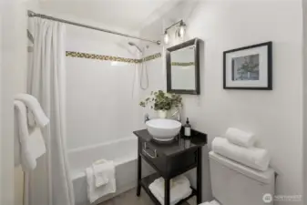 Bathroom is off hallway between kitchen and bedroom