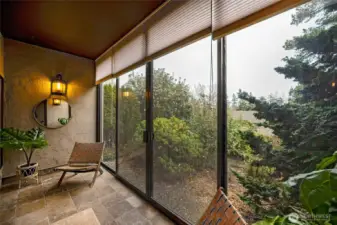 The sunroom's blinds provide privacy when extended floor to ceiling.
