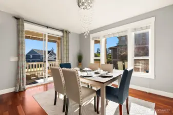 Dining area off kitchen leads to balcony deck.