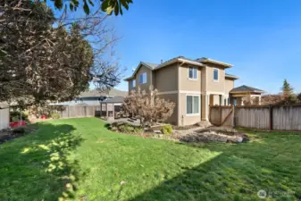 Fully fenced backyard, garden beds and mature landscape waiting to pop in spring!