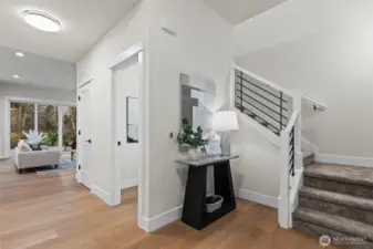 As you enter the foyer, stairs and powder room on left, large great room in front