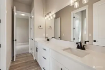 Dual vanities and compartmentalized shower/commode (out of frame to the left) in the Jack and Jill bathroom