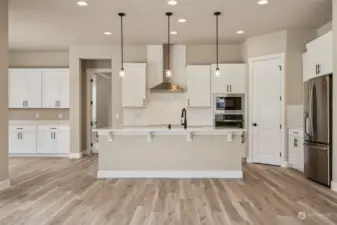 View of kitchen. Built-in buffet with upper cabs in the dining area shown on the left