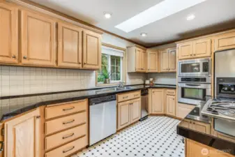 Beautiful kitchen with stainless steel appliances including trash compactor.