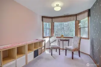 Primary suite has sitting area to look out beautiful backyard and greenbelt