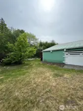Large sliding door access to side of shop. Lots of space for riding lawnmower, atv, etc
