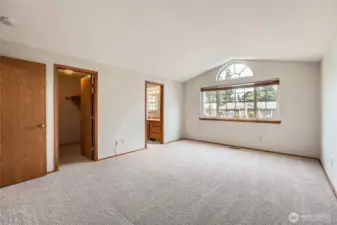 Primary bedroom with vaulted celings.