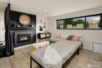 Lower level open media/rec room with gas fireplace and remote control shades. Perfect for a game room.