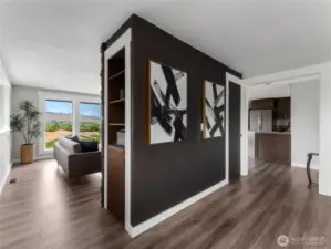 Fireplace wall separating bonus room and main living room area.