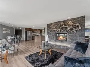 Striking fireplace serves as the focal point of the elegant living area.