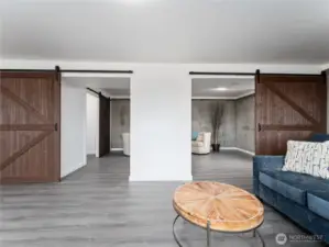New barn doors create a stylish division for a private living space.